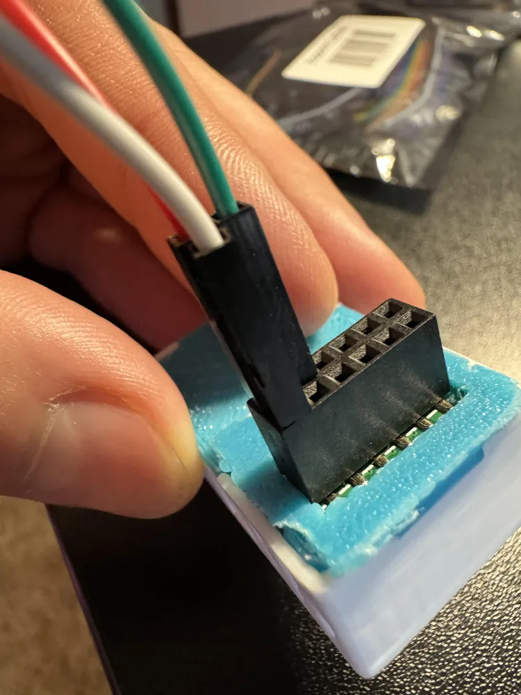 DuPont wires pushed onto the 5V, GND, and IO7 pins
