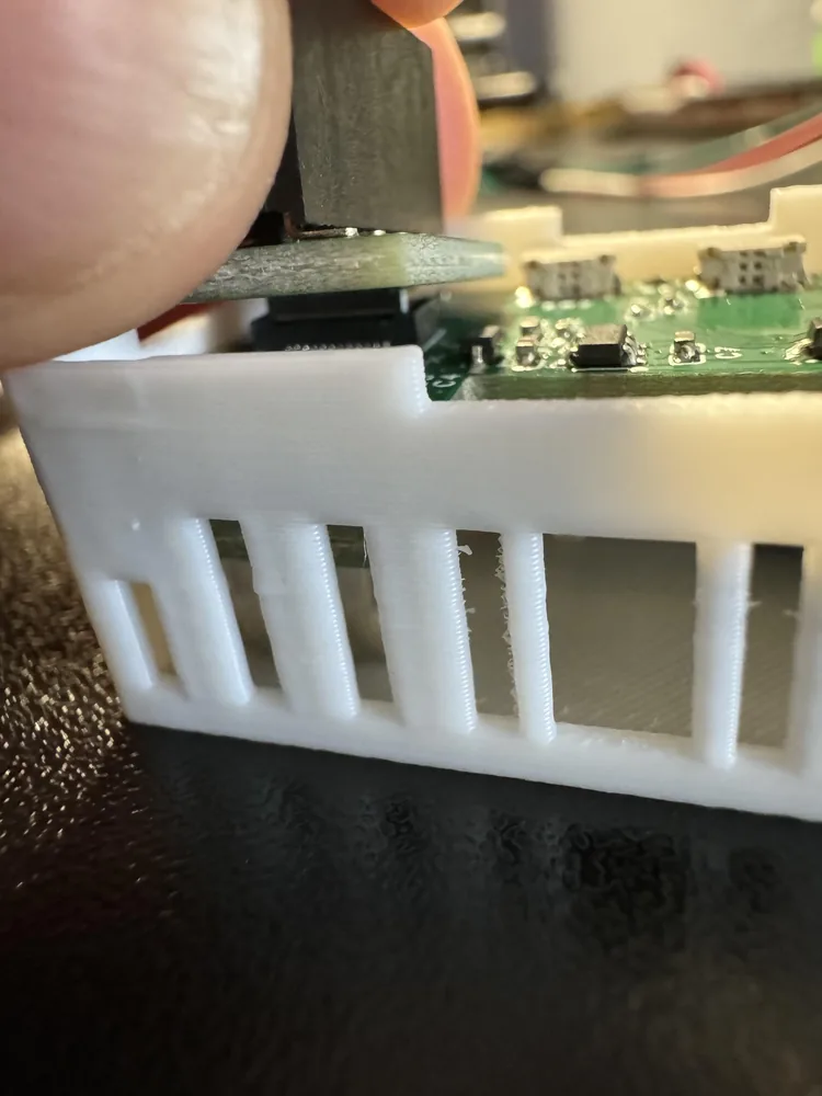 A thumb pressing the GPIO Header onto the mezzanine connector